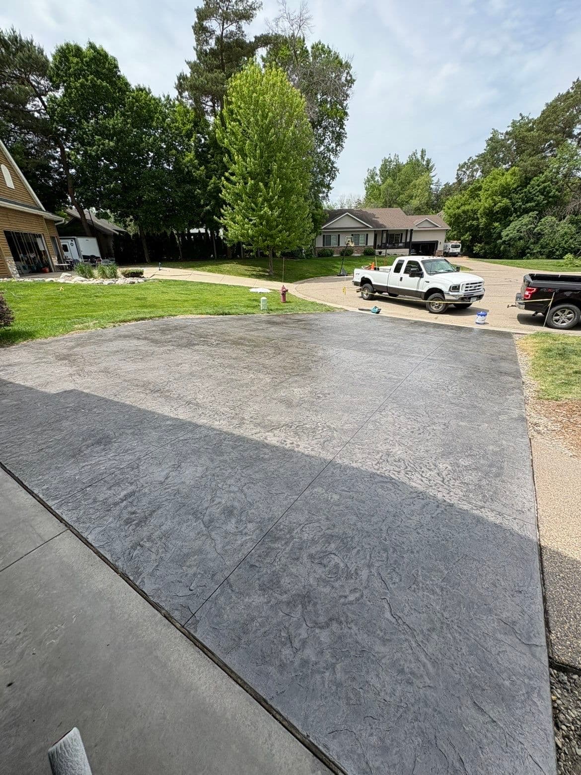 Slate Gray Roman Slate Stamped Concrete Driveway with Black Accent image