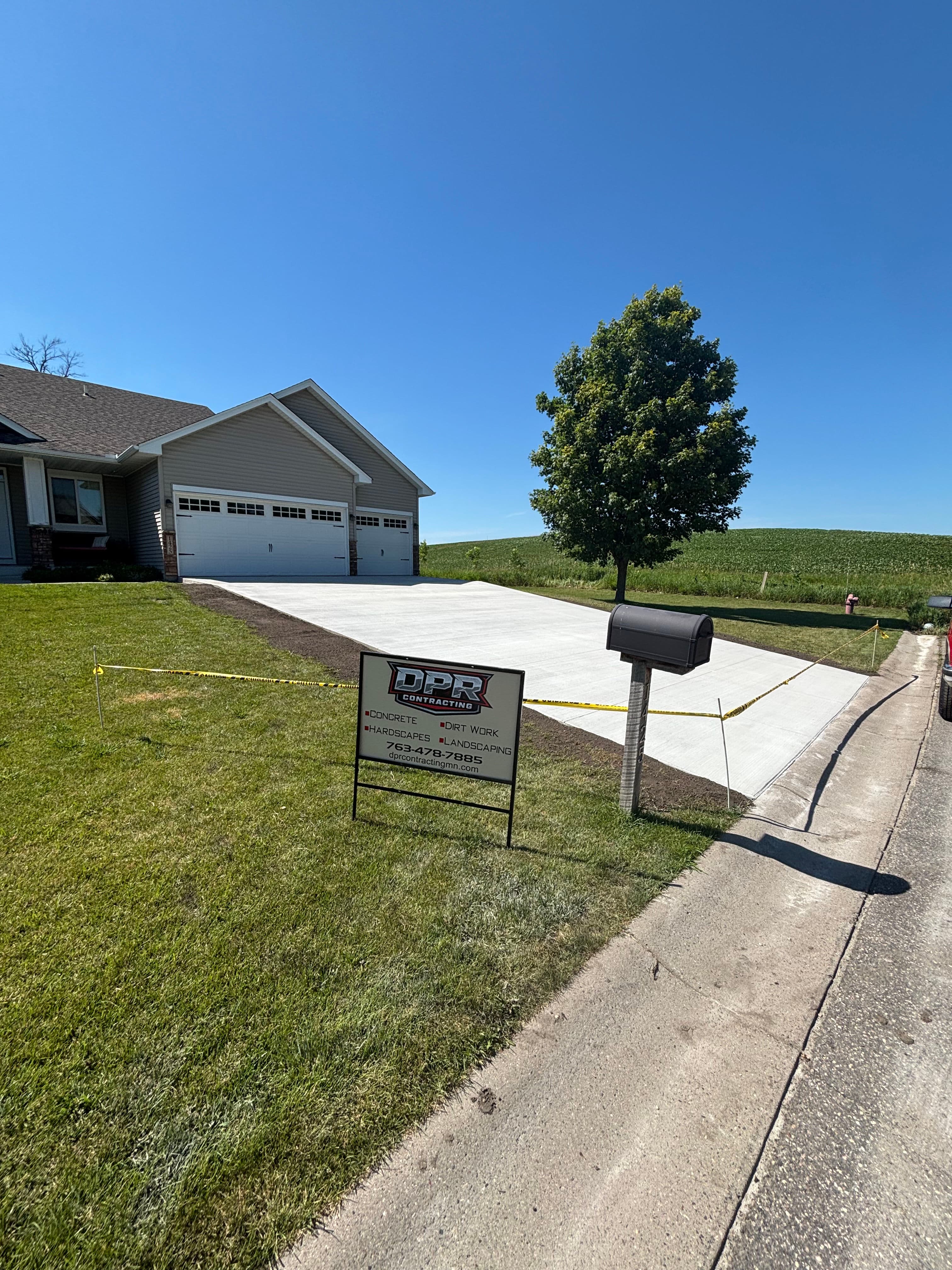 Project Cracked Asphalt Out, Fresh Concrete Driveway In image