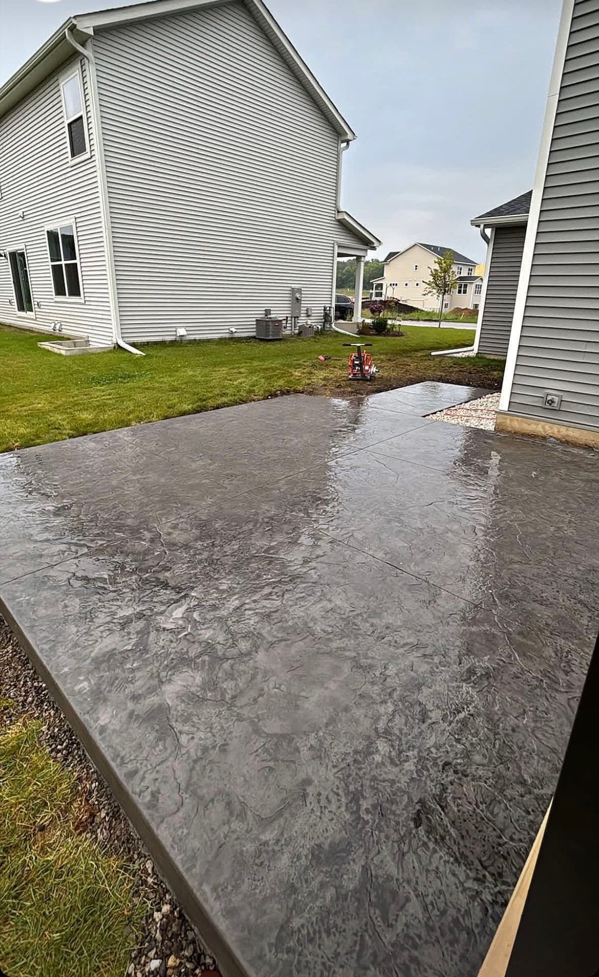 Stamped Patio, Rock Beds, and Fresh Landscaping That Actually Holds Up image